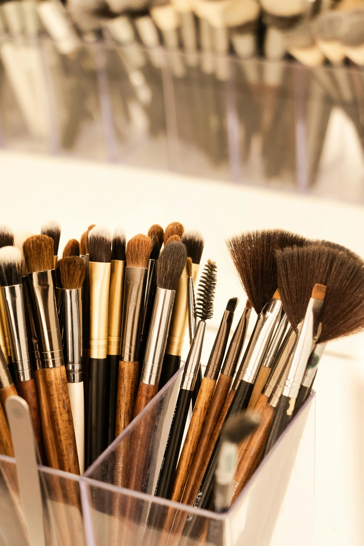 High-quality close-up of synthetic makeup brushes arranged neatly in a holder, showcasing a variety of shapes and sizes for beauty application.