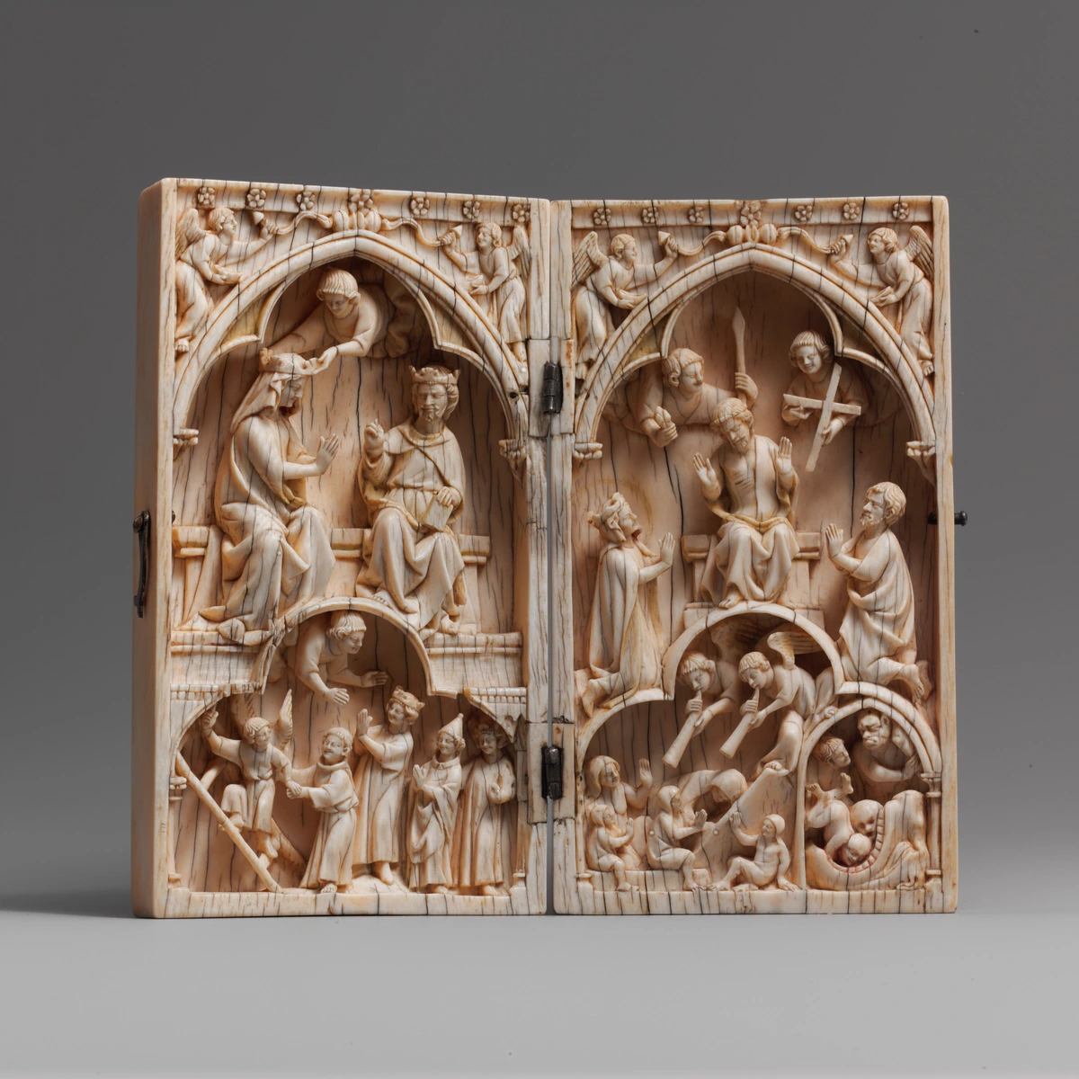 Ivory diptych depicting the Coronation of the Virgin on the left and the Last Judgment on the right, with angels and figures in Gothic architectural settings.