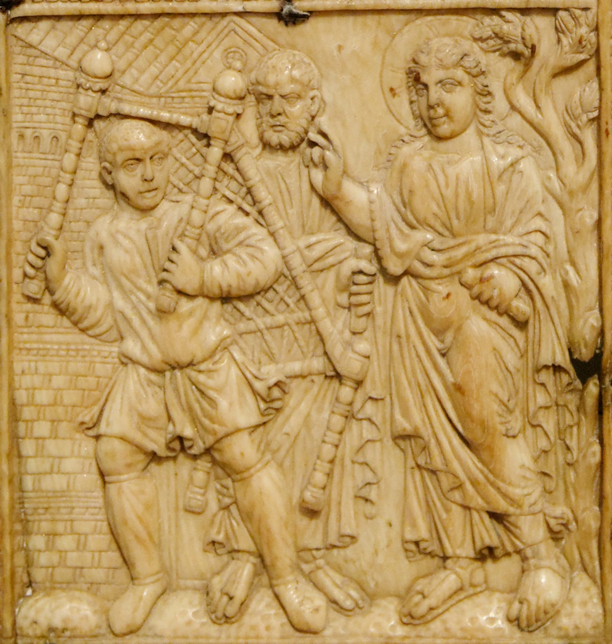 Diptych panel depicting miracles of Christ, featuring figures carrying staffs in procession, with architectural and natural elements.