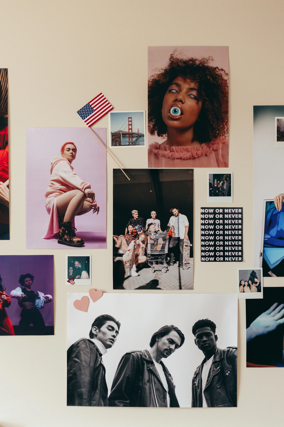 A diverse collection of fashion and art posters, including portraits, group photos, and iconic landmarks, arranged on a wall.