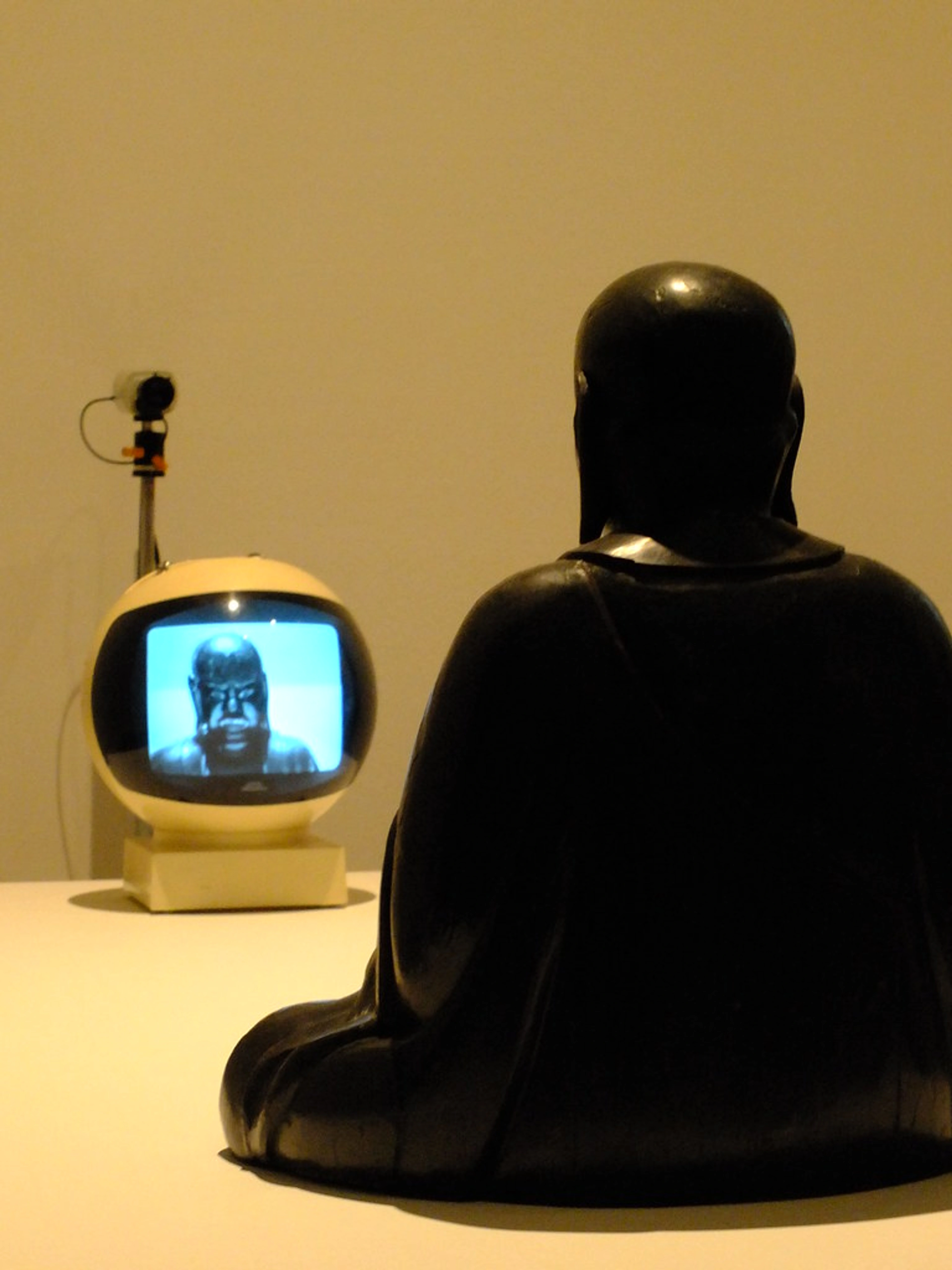 Nam June Paik's TV Buddha sculpture with a monitor displaying the sculpture's image.