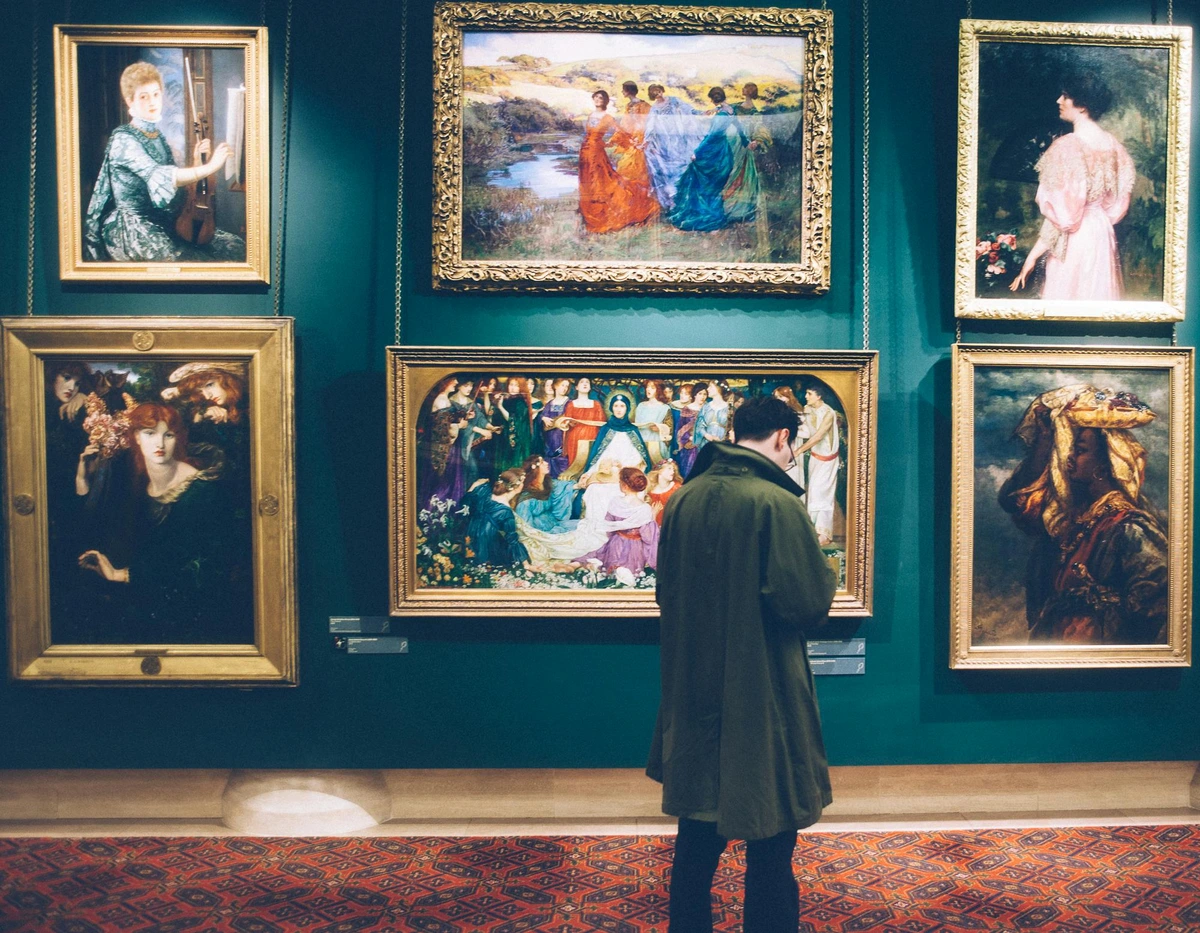 Man examining artwork in a modern art gallery.