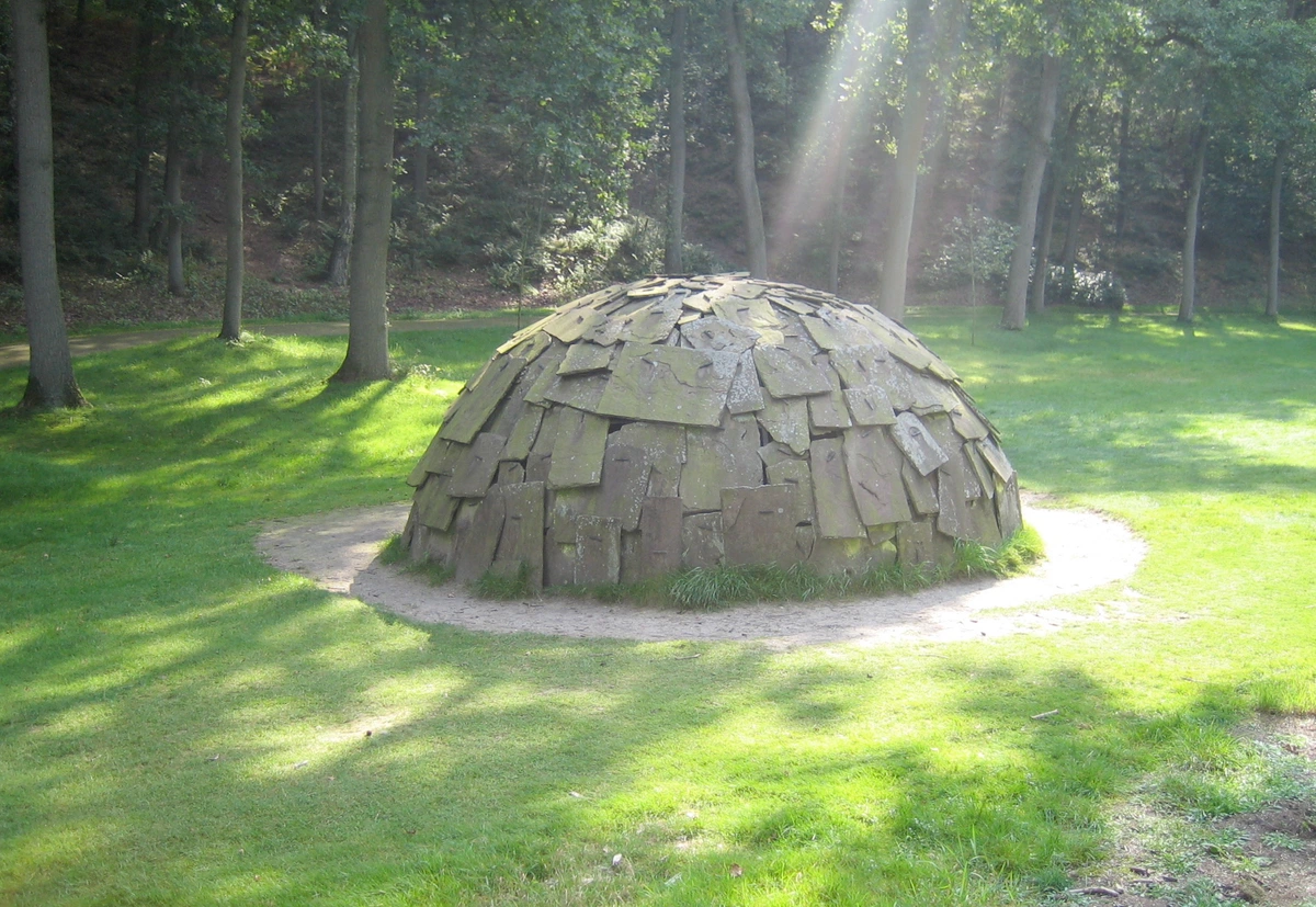 Merz Igloo sculpture made of stone slabs in a park
