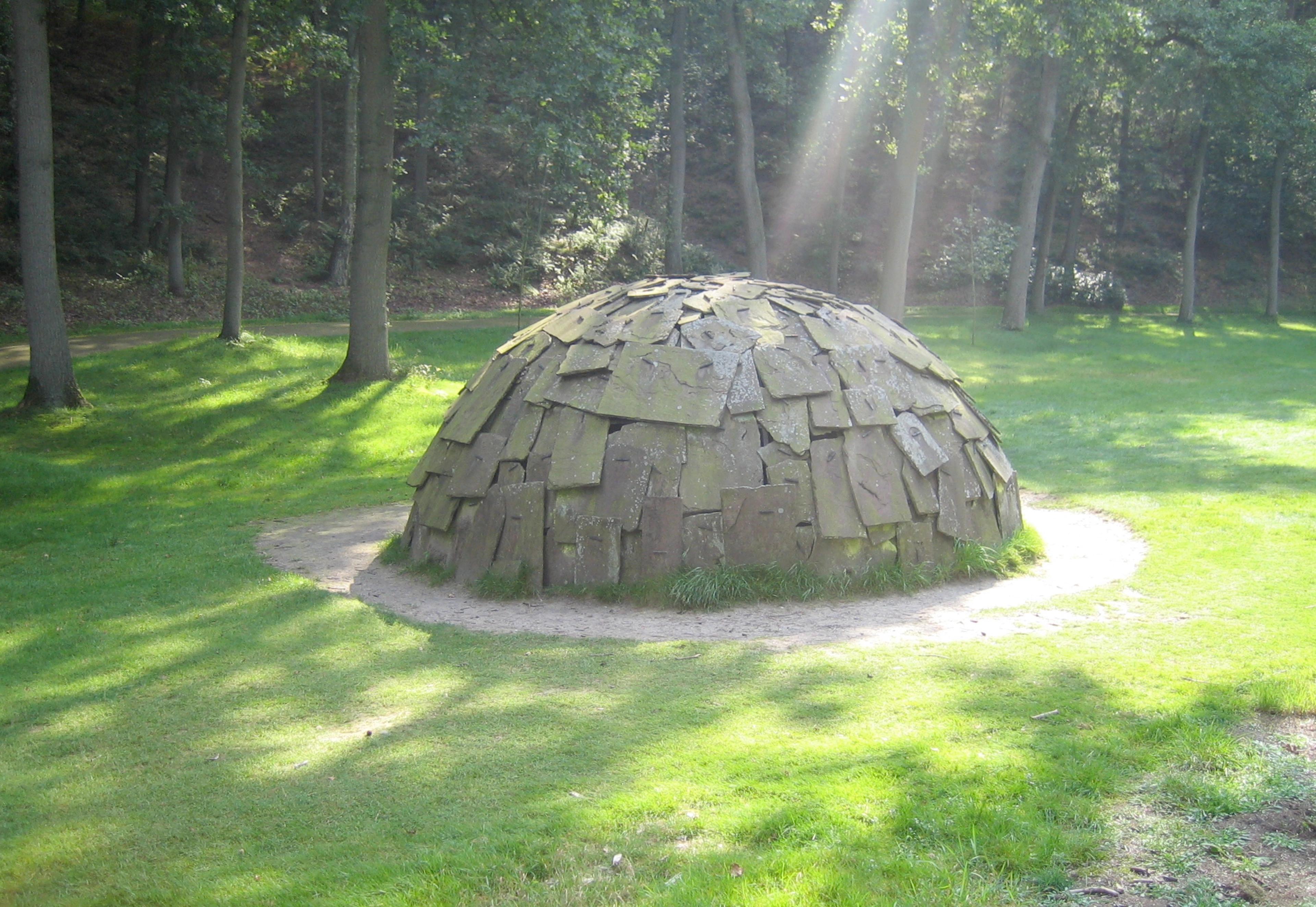 Merz Igloo sculpture made of stone slabs in a park