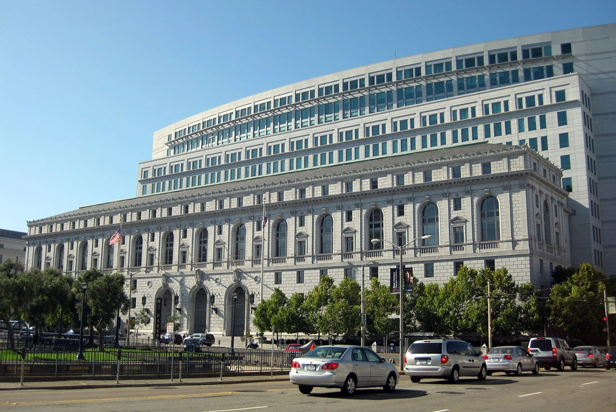San Francisco Civic Center and California State Office Building showcasing white stone architecture with classical columns against a clear sky.
