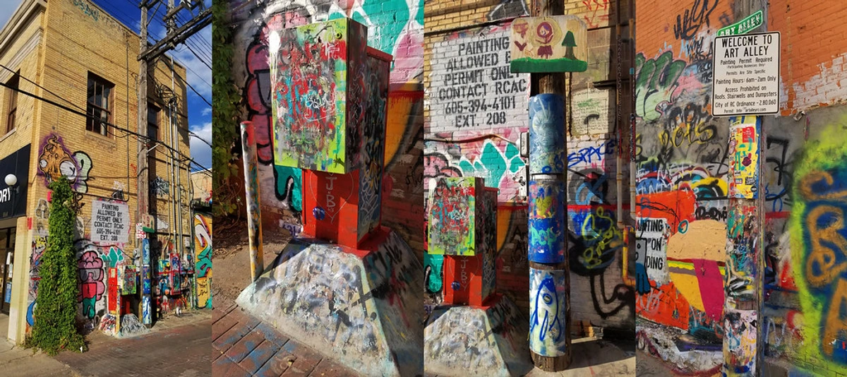 Vibrant 'ART ALLEY' mural capturing Rapid City's community spirit and artistic heritage, showcasing a colorful serpentine stone wall with 'Art in the City' theme.