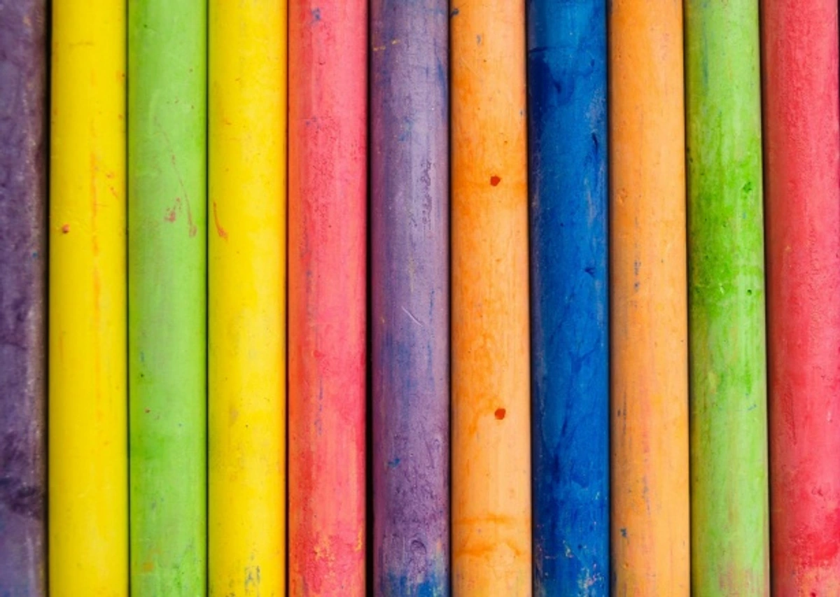 A close-up, vibrant row of colorful chalk pastels, perfect for back-to-school art projects.