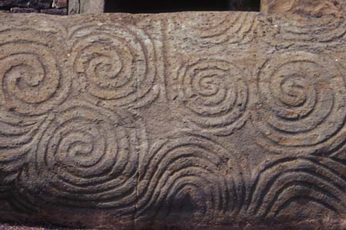 Intricate spiral carvings on the entrance stone of Newgrange, a prehistoric passage tomb in Ireland.