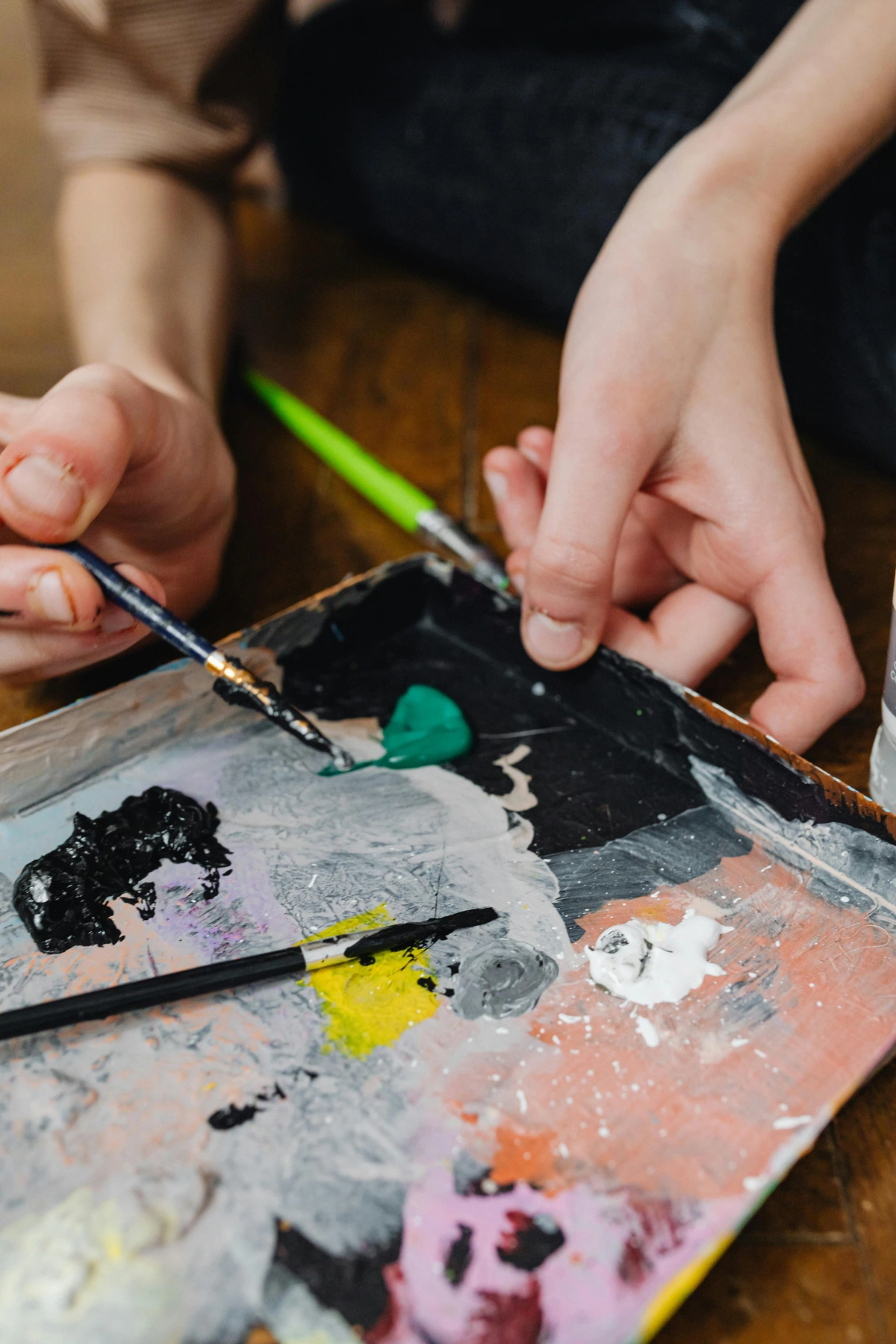 A professional artist demonstrating precise paintbrush techniques in a studio setting.