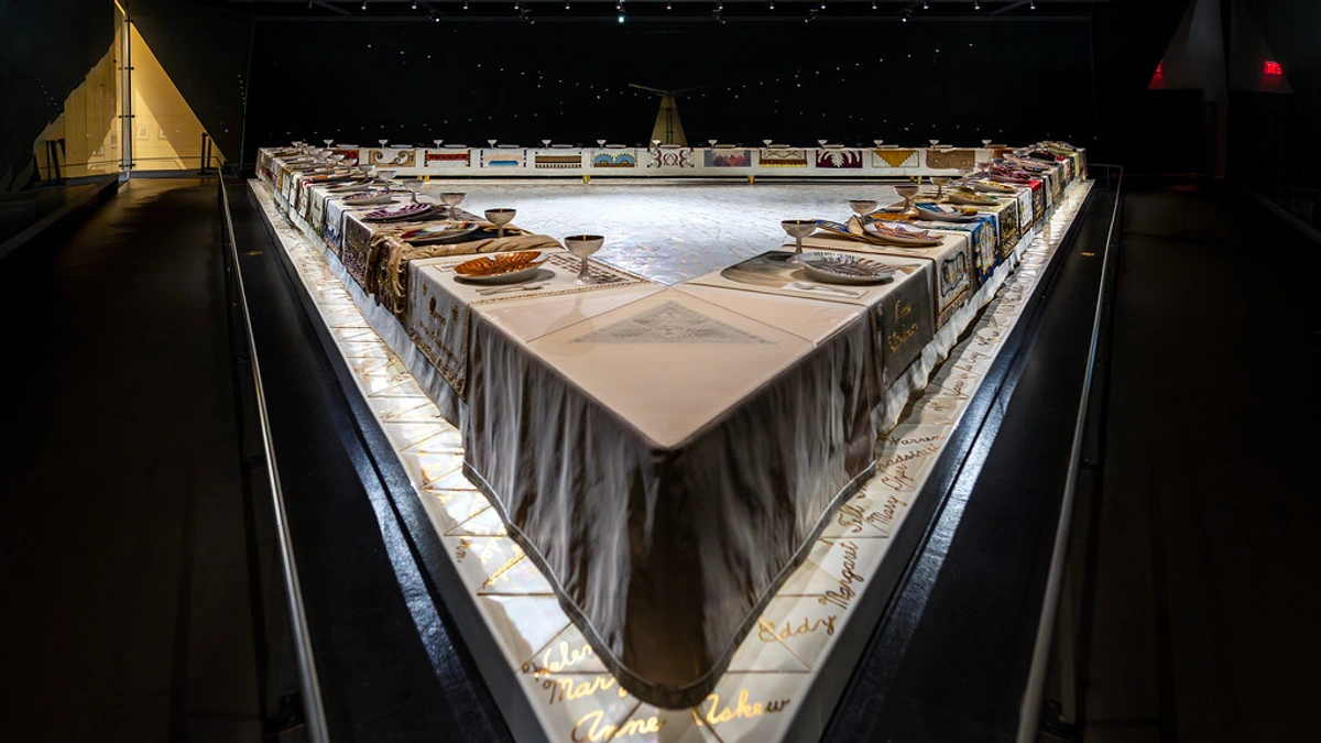 Judy Chicago's The Dinner Party installation, featuring a large triangular table with elaborate place settings for iconic women.