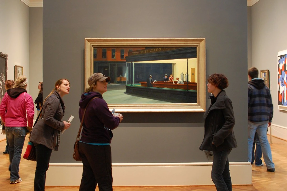 Visitors observe Edward Hopper's iconic painting 'Nighthawks' at the Art Institute of Chicago.