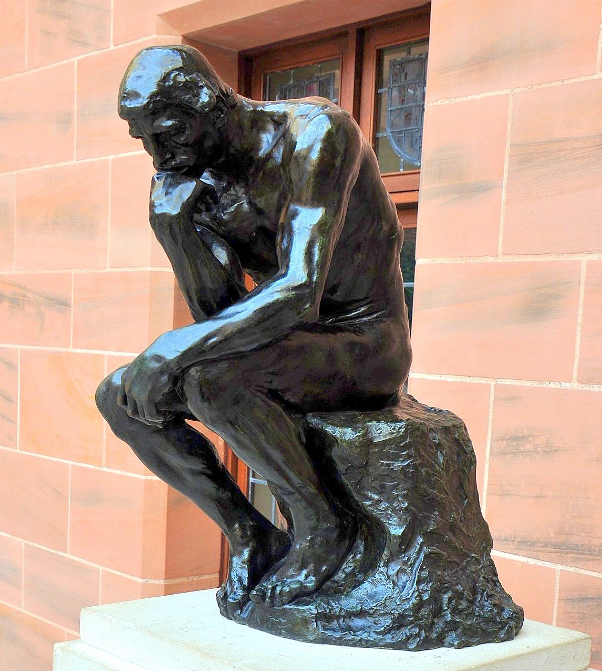 The Thinker statue by Auguste Rodin, a bronze sculpture of a man in deep contemplation.