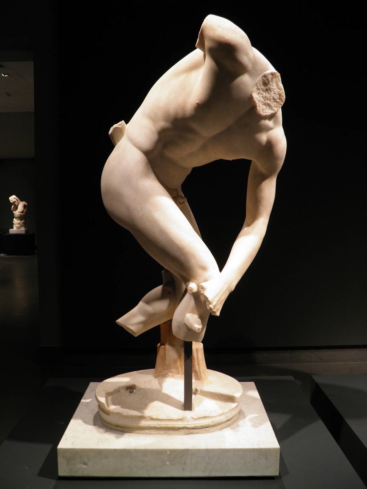 Fragmentary marble statue of a Discobolus of the Lancellotti type, depicting an athlete in the motion of throwing a discus.