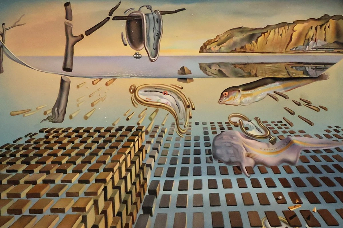 Salvador Dalí's The Disintegration of the Memory painting, featuring melting clocks draped over objects in a dreamlike landscape.