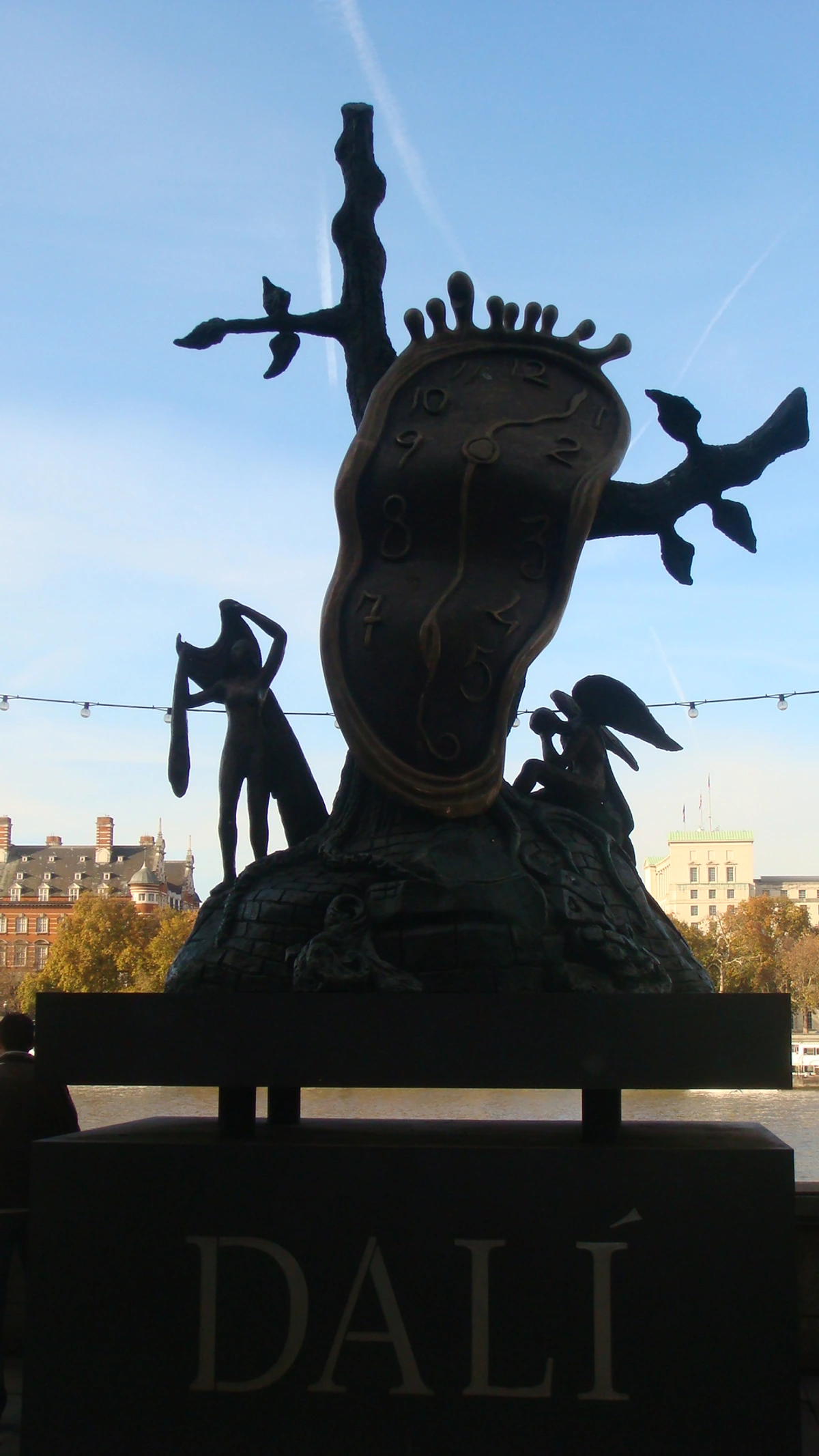 Salvador Dali's melting clock sculpture, inspired by 'The Persistence of Memory', displayed near the London Eye.