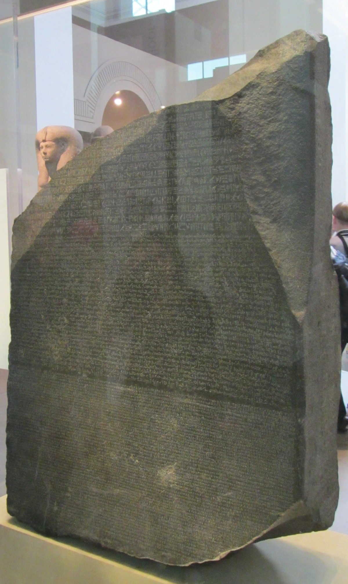 The Rosetta Stone on display at the British Museum, showcasing its three distinct scripts.