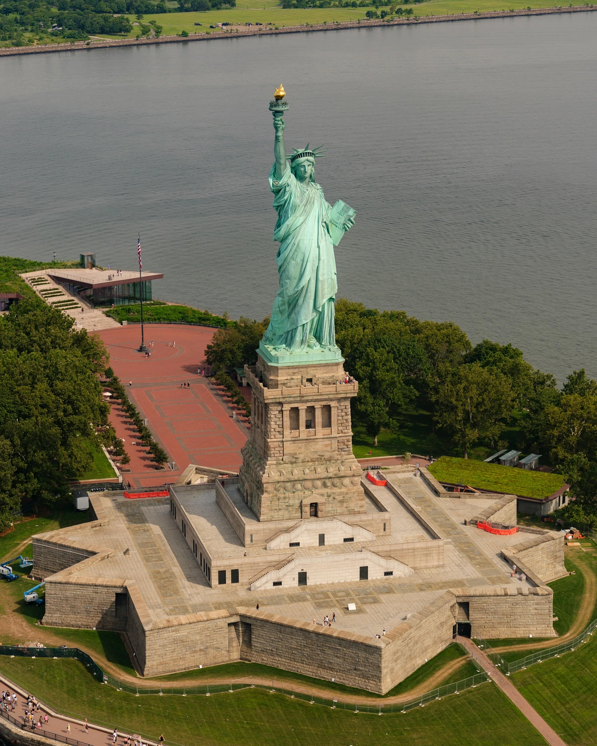 Aerial view of the Statue of Liberty in New York City, holding a torch and tablet.
