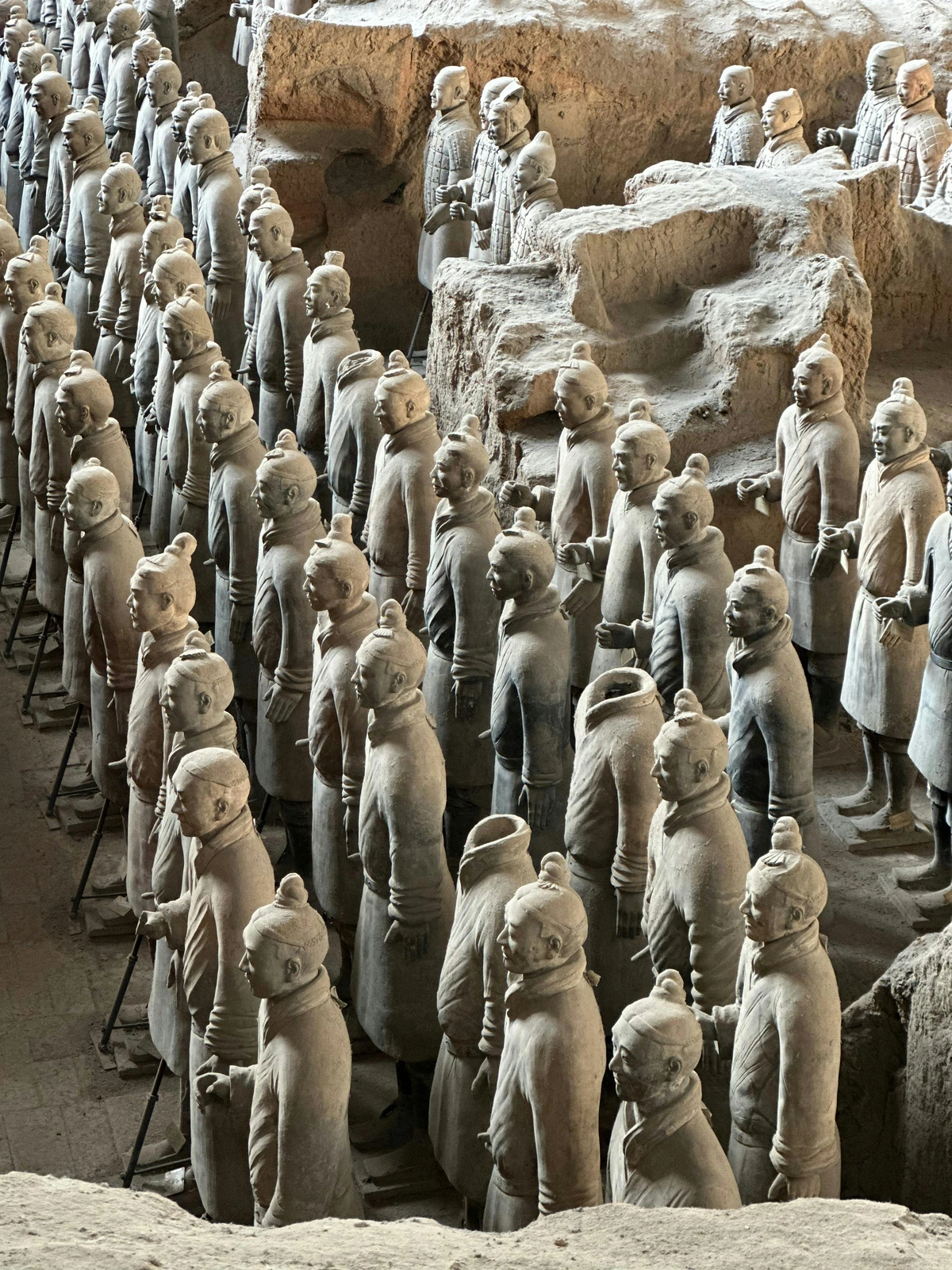 Terracotta Warriors exhibit in Xi'an, China, showcasing rows of life-size clay soldiers.