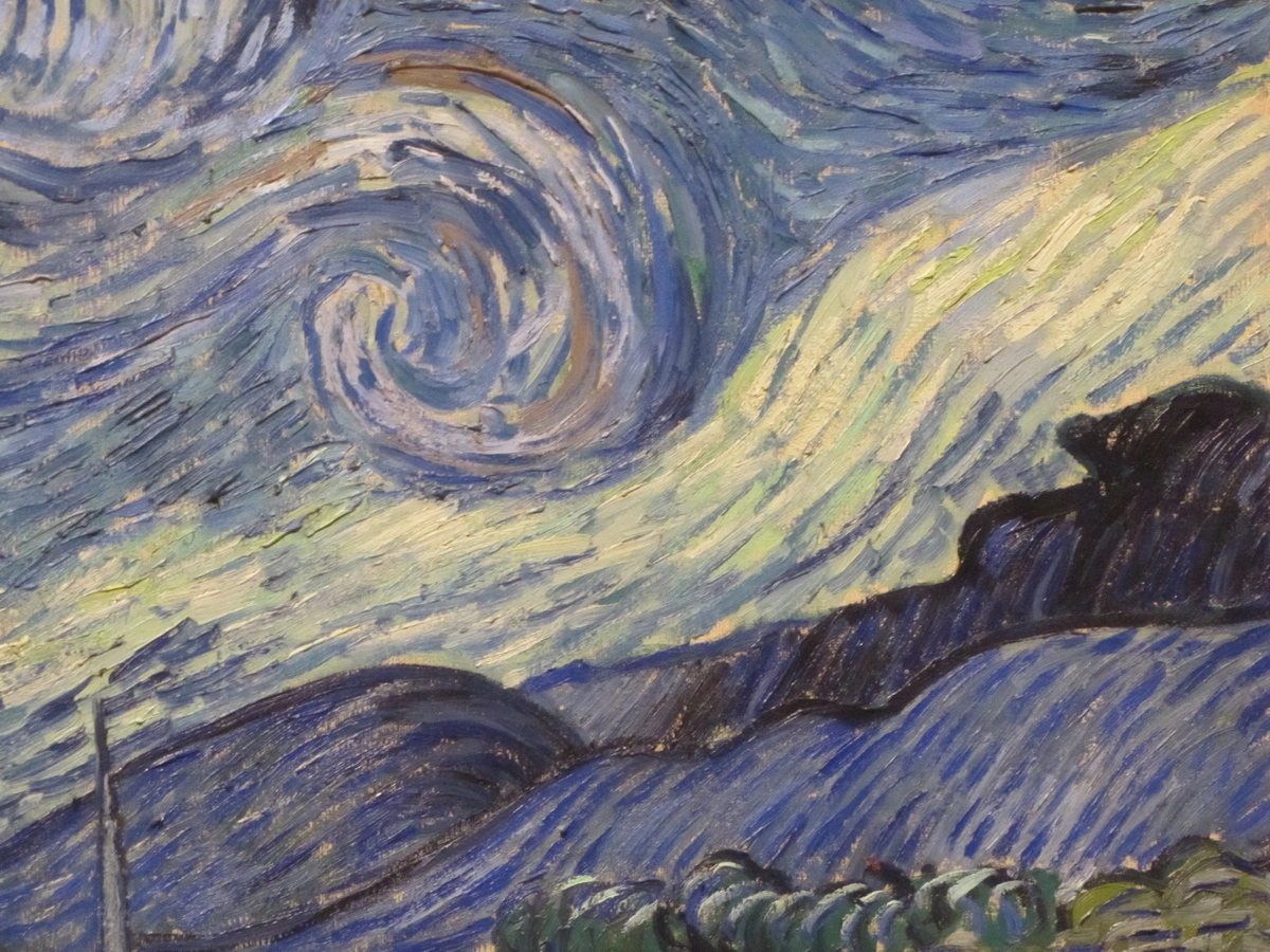 Detail of Van Gogh's Starry Night showing swirling sky and dark hills