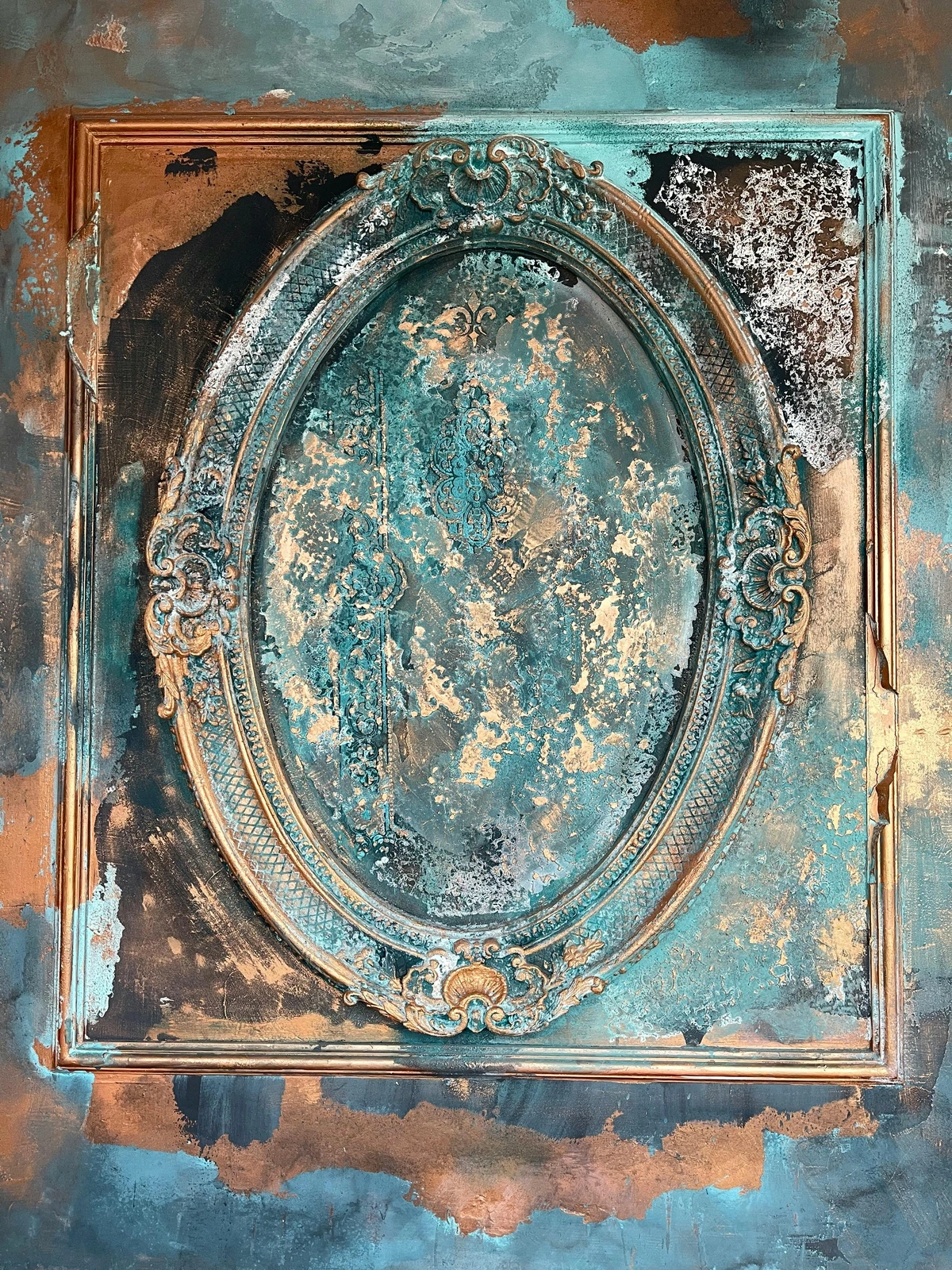 Ornate oval frame with a verdigris patina effect, set against a distressed textured background in teal, gold, and bronze tones.