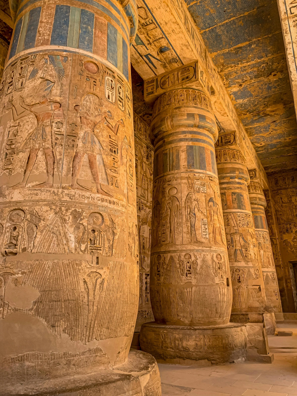 Ancient Roman columns in Luxor, Egypt, showcasing enduring hieroglyphic carvings