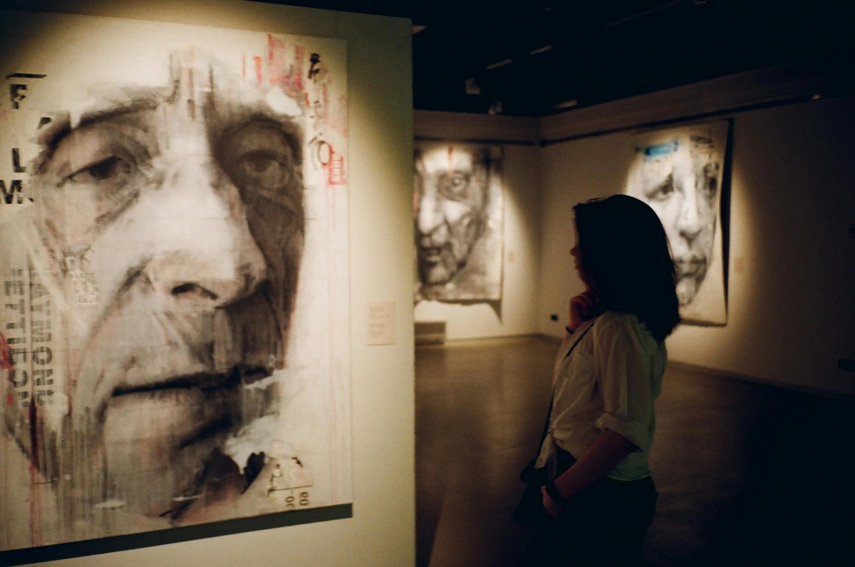 woman-observing-large-black-and-white-painting-in-modern-art-gallery-with-artistic-insight