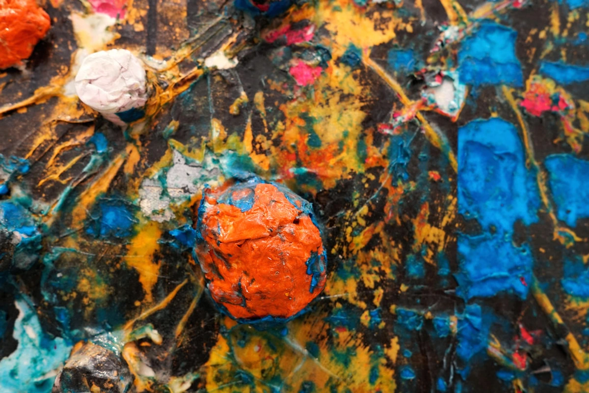 Detail of Mark Bradford's abstract sculpture 'Deep Blue', showcasing vibrant orange and blue textures.