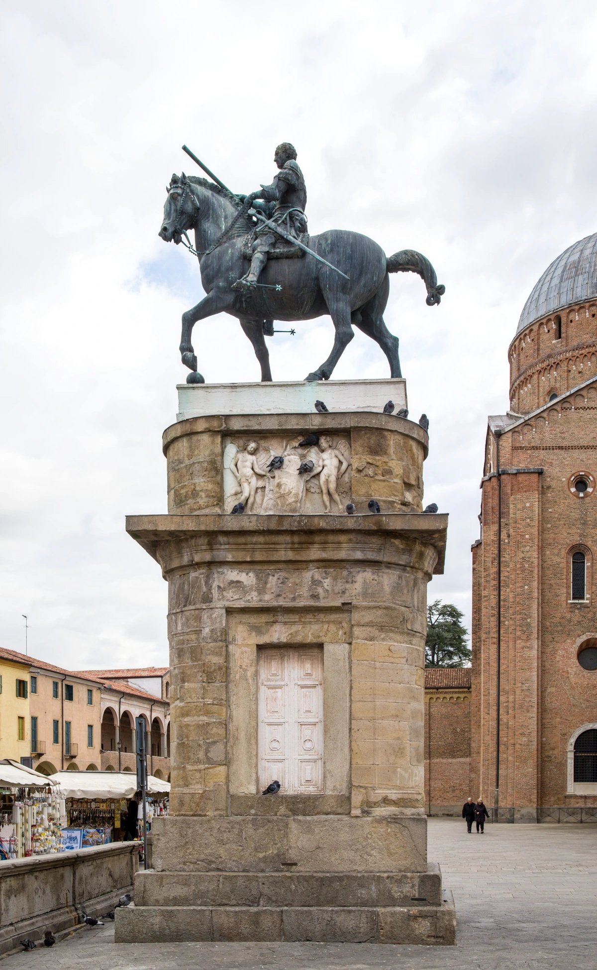 Equestrian statue of Gattamelata by Donatello in Padua, Italy, with St. Anthony's Basilica in the background.