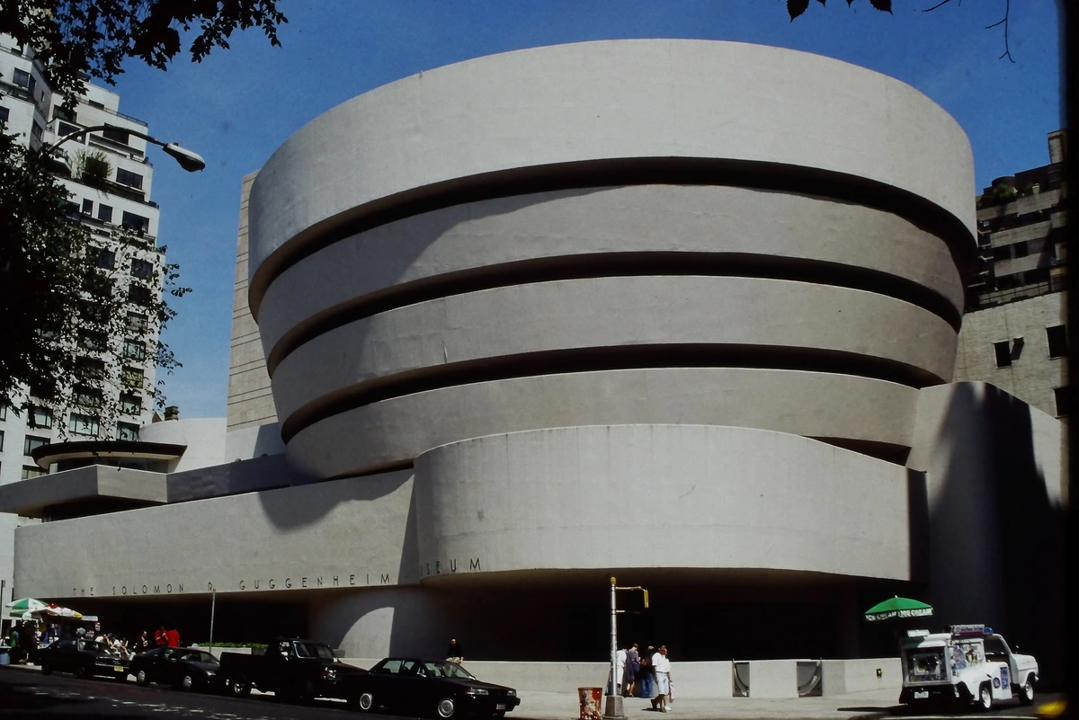 The iconic Solomon R. Guggenheim Museum in New York City, designed by Frank Lloyd Wright, showcasing its distinctive spiral architecture on a sunny day.