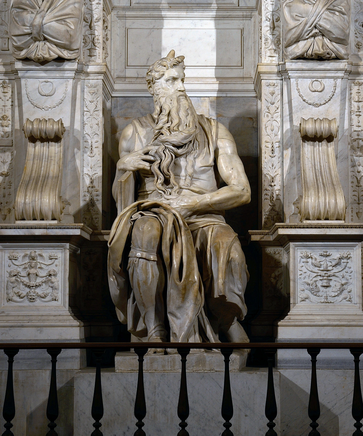 Michelangelo's powerful marble sculpture of Moses, seated with a flowing beard and horns, in San Pietro in Vincoli, Rome.