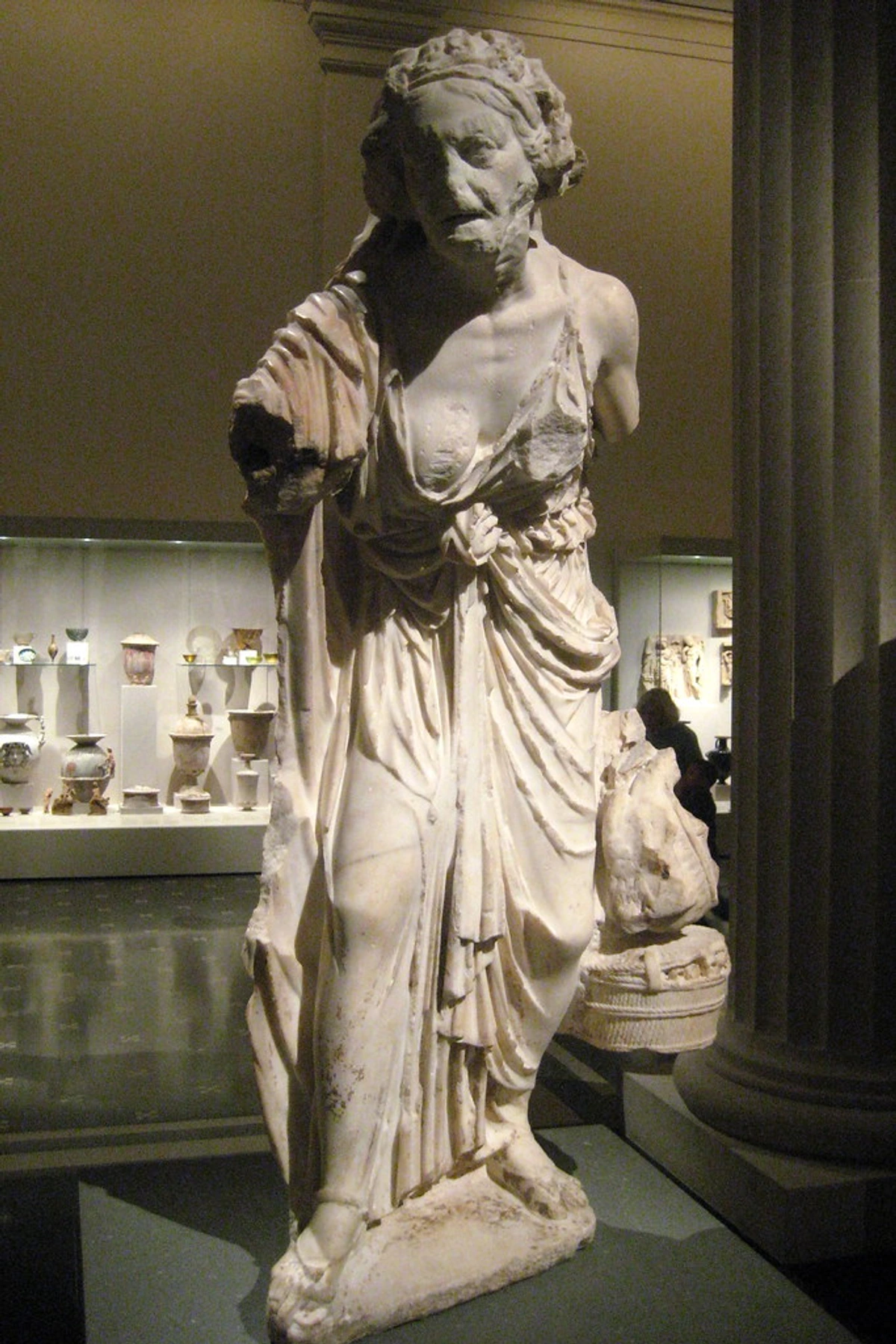 Marble statue of an old man, ancient Greek or Roman sculpture at the Metropolitan Museum of Art.