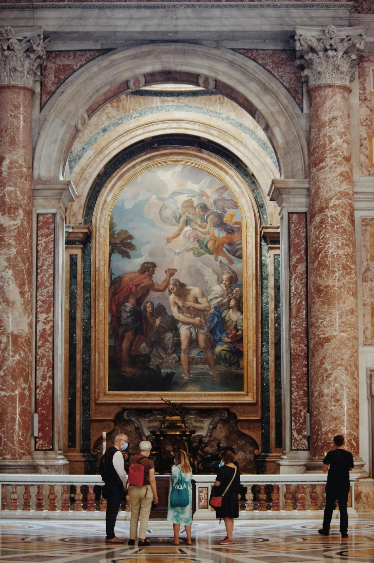 Visitors in an art museum admiring a Renaissance fresco with religious and historical figures in an ornate classical setting.