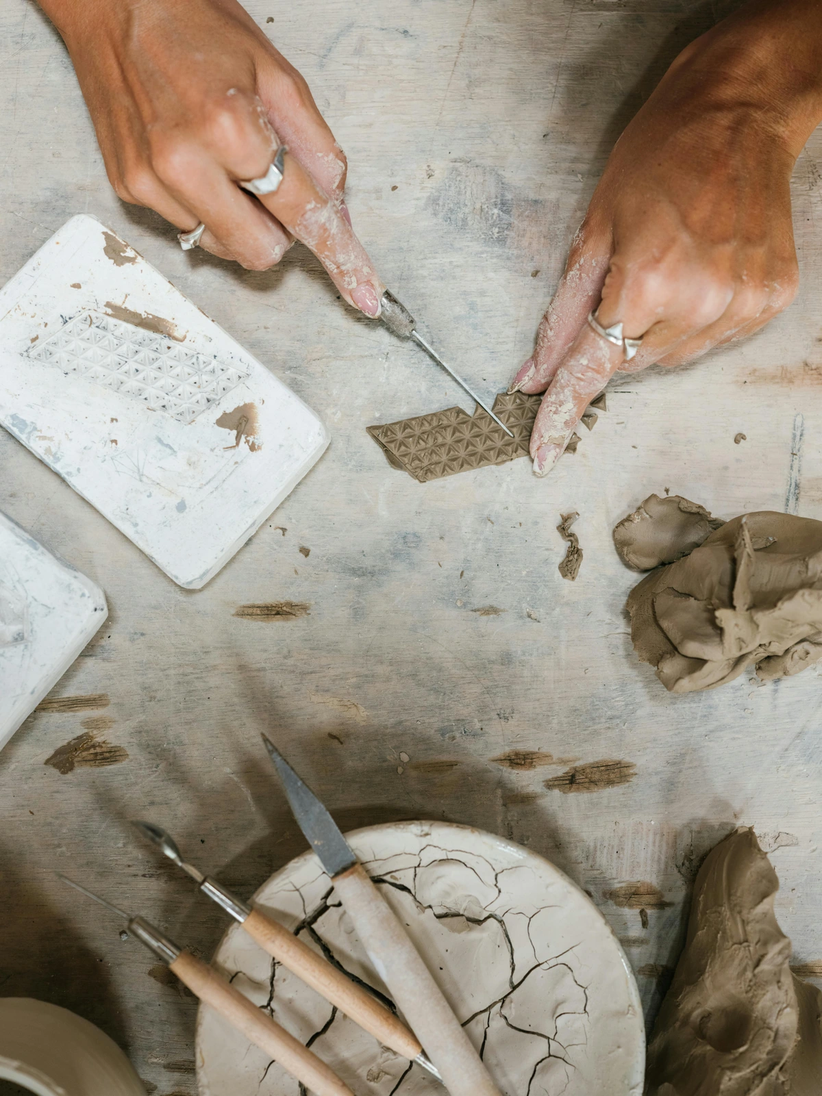 Hands shaping clay for art creation, symbolizing the meaning and process of artistic expression.