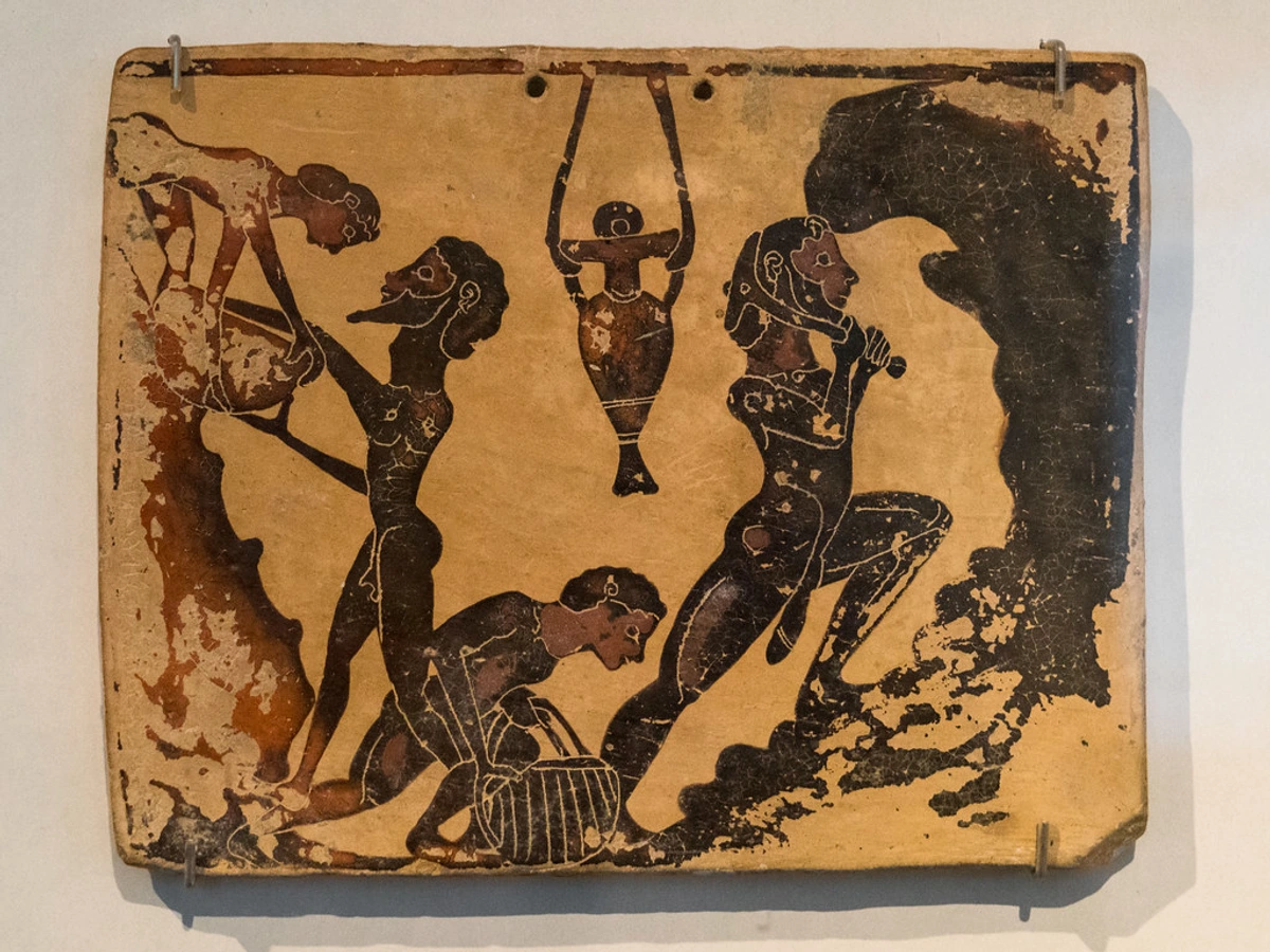 Ancient Greek artisan demonstrating ancient pottery techniques in Corinth, showcasing clay extraction and craftsmanship.