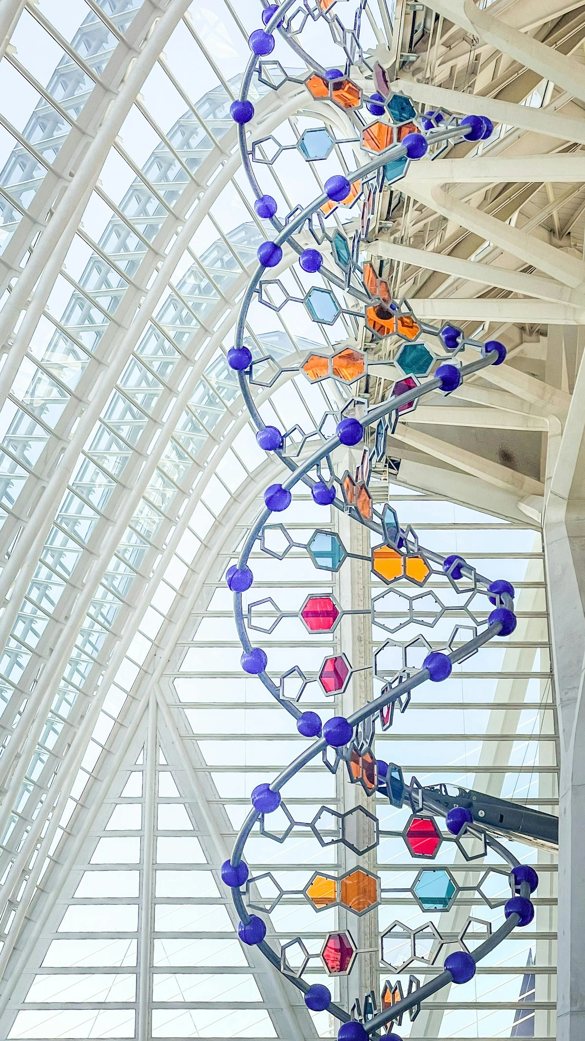 Modern DNA sculpture with colorful hexagonal bases inside the City of Arts and Sciences, Valencia