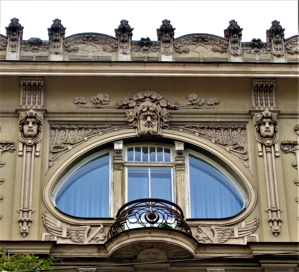 Art Nouveau facade in Riga with ornate details and a distinctive oval window, showcasing the architectural richness of the style
