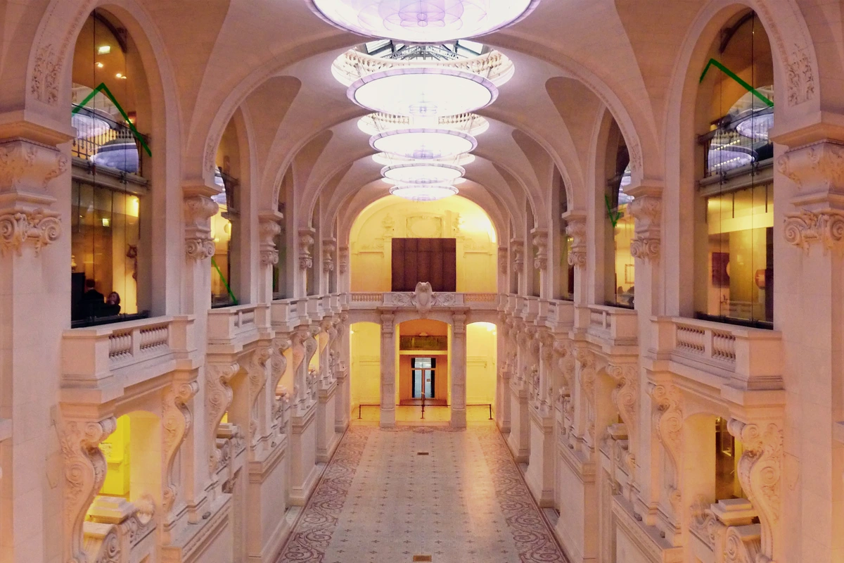 Interior view of the Musée des Arts décoratifs in Paris, showcasing its grand architecture with arched ceilings, ornate columns, and decorative floor, reflecting the elegance that influenced Rococo design.