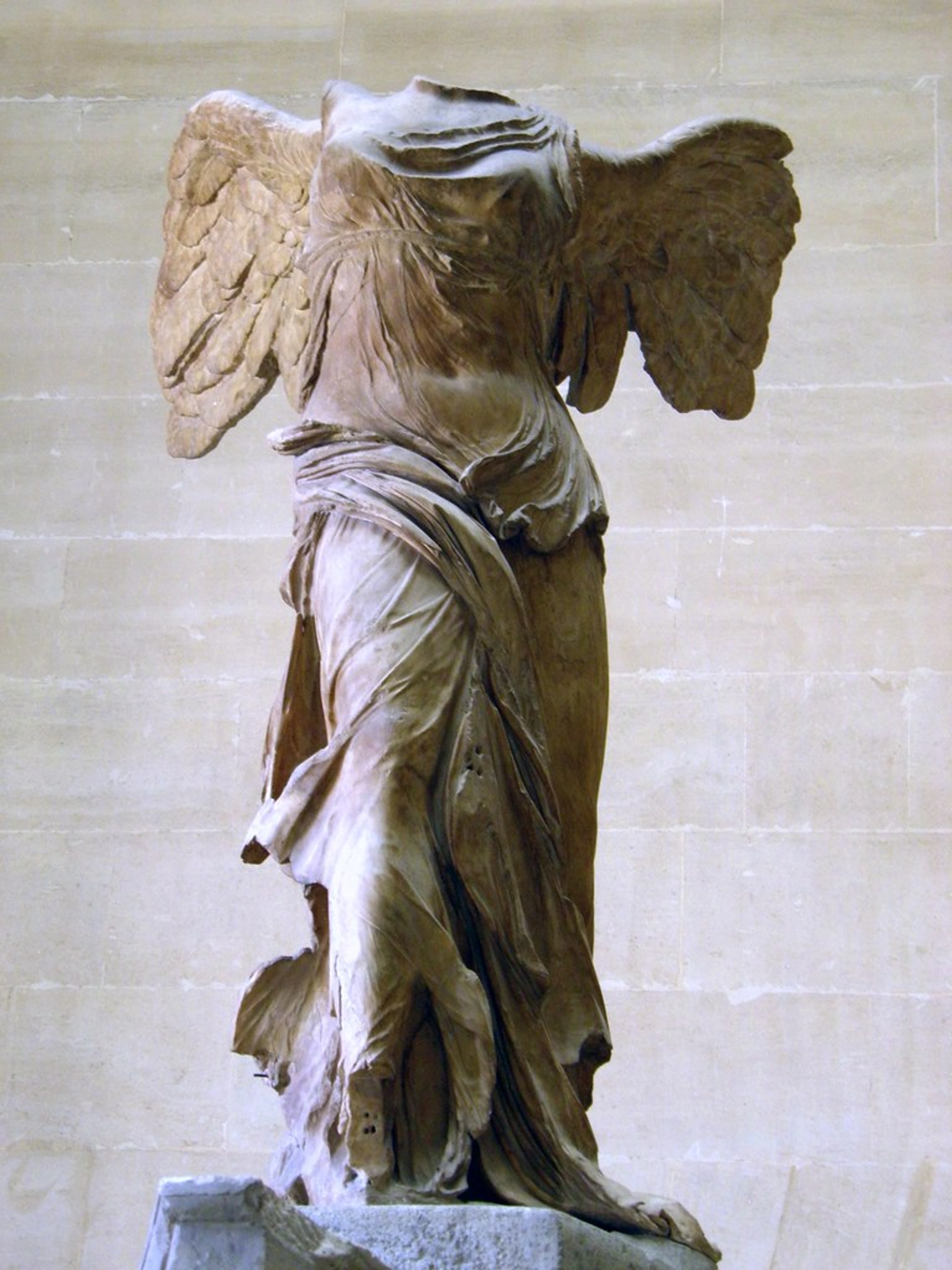 The Winged Victory of Samothrace, a headless marble statue of Nike, the Greek goddess of victory, displayed at the Louvre Museum in Paris.