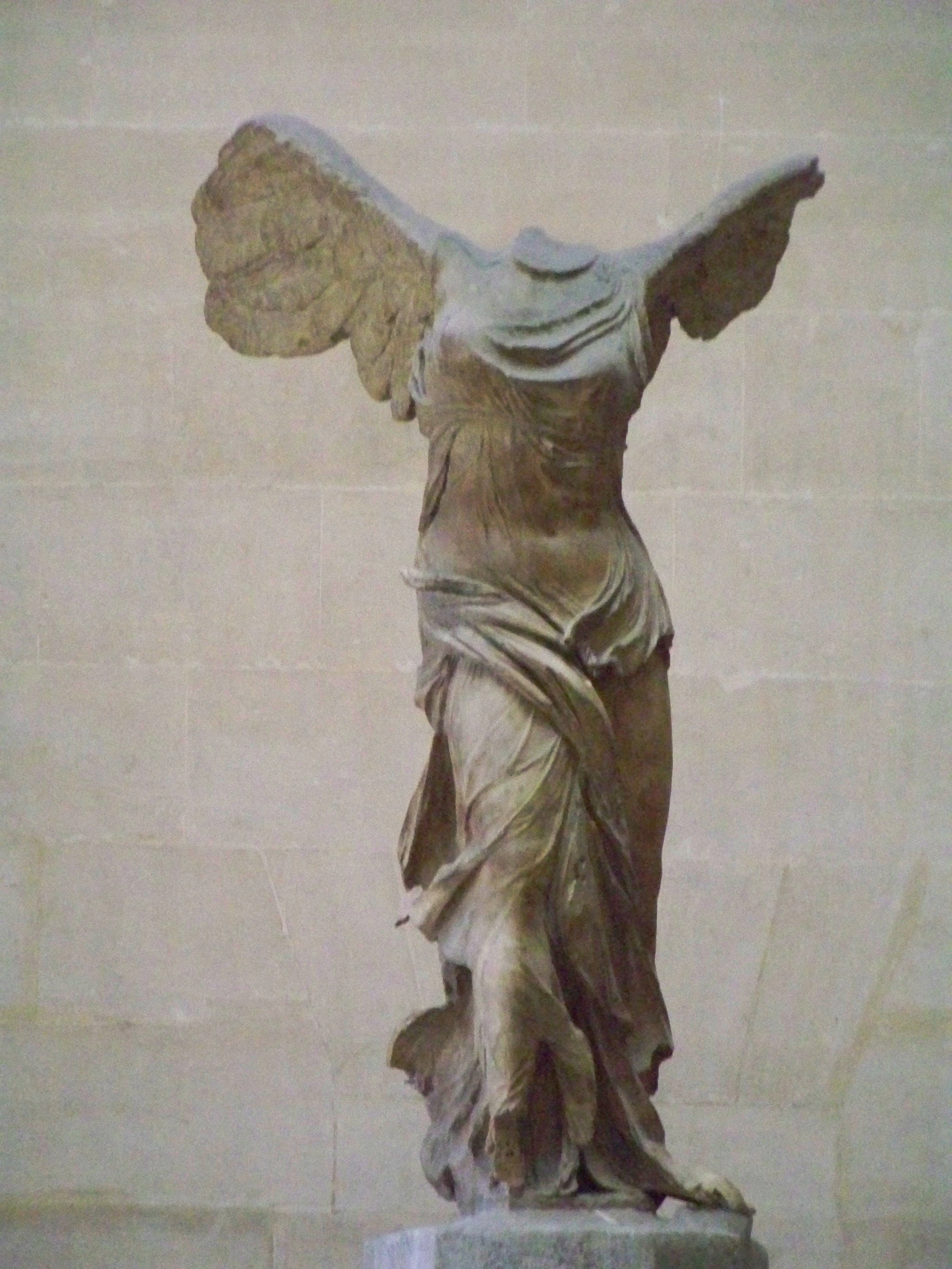The Winged Victory of Samothrace, a headless marble statue of Nike, the Greek goddess of victory, displayed at the Louvre Museum.