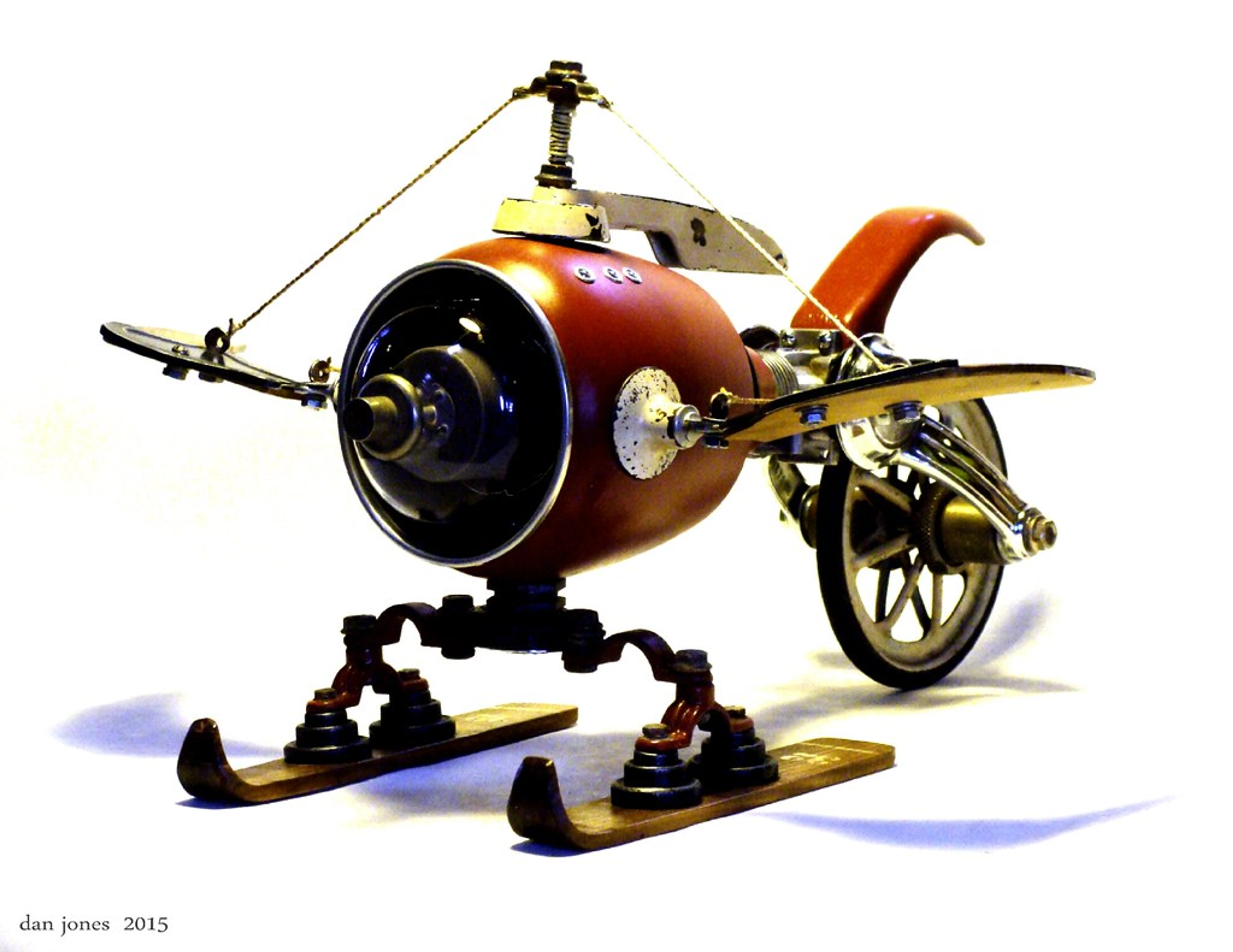 Olliehopter found object assemblage sculpture, dieselpunk style, with skis and propeller details.