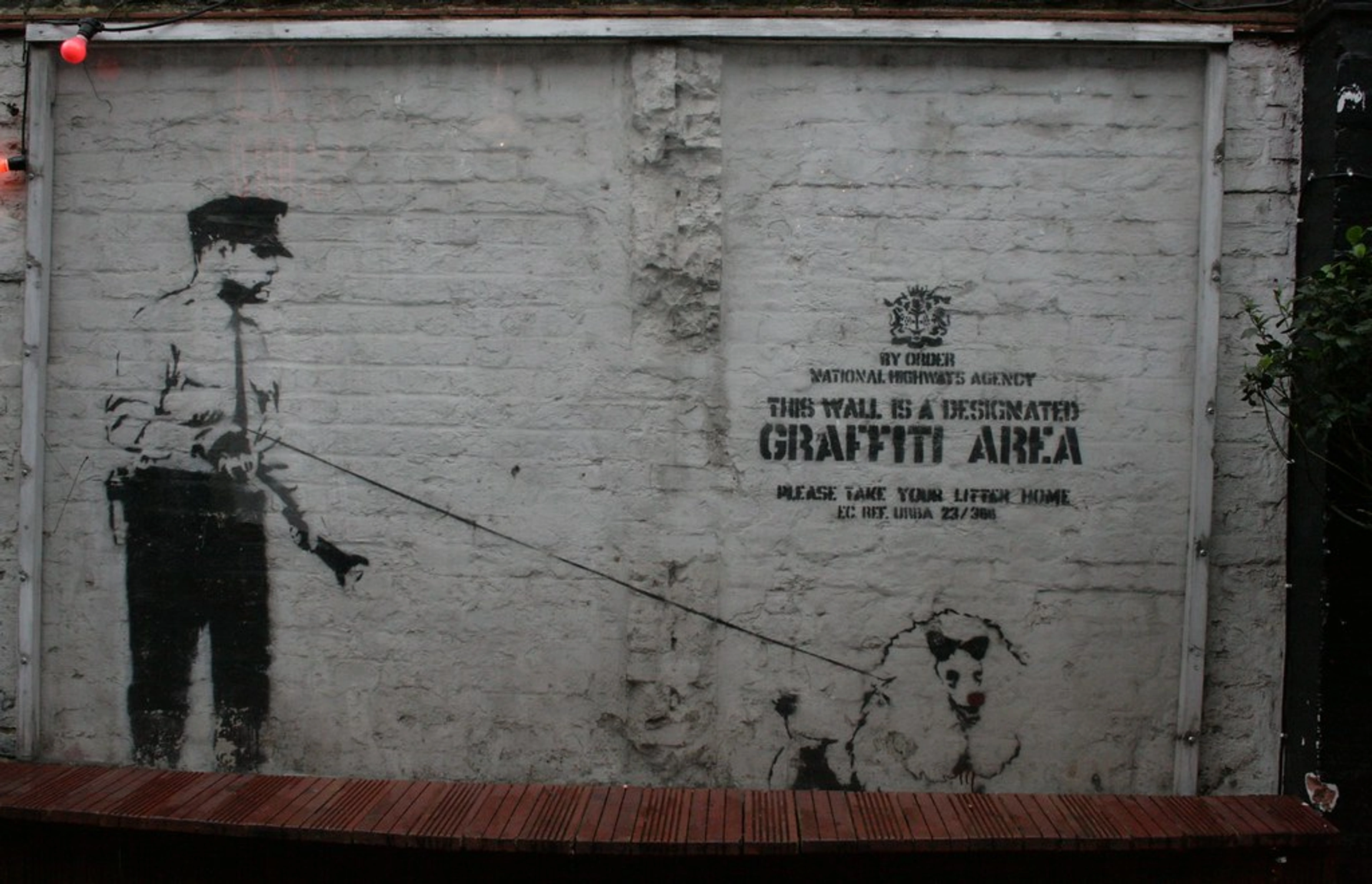 Banksy's 'Follow Your Dreams Cancelled' mural in Boston, depicting a man painting on a wall.
