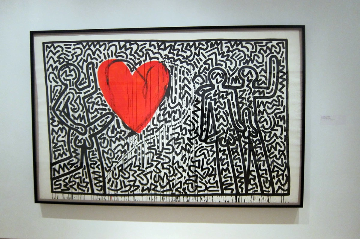 Keith Haring style artwork of three dancing figures: green, red, and blue, on a yellow background.