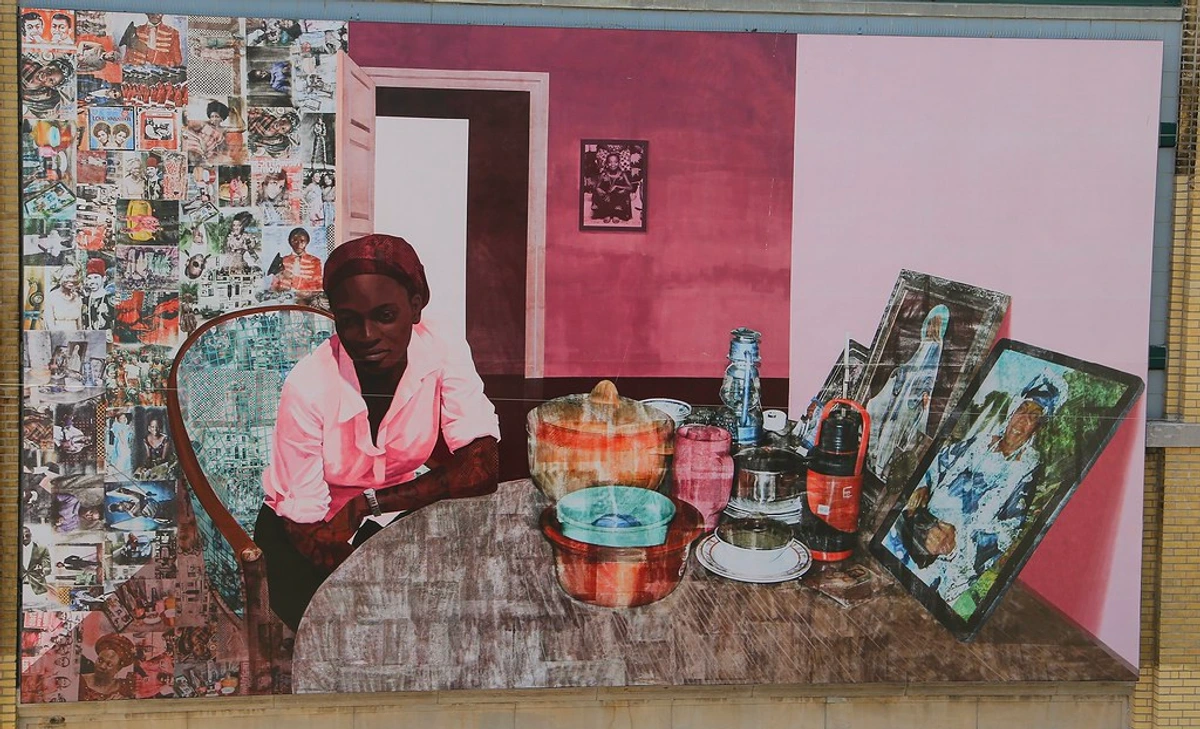 Large-scale mural 'The New On-Site' by Njideka Akunyili Crosby on Manhattan's High Line, featuring a woman at a table with collage elements and painted household items.