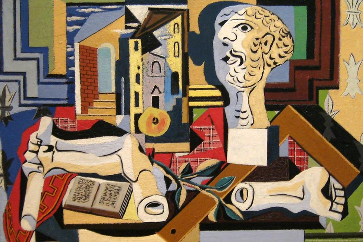 Cubist still life by Pablo Picasso featuring a plaster head, bones, a book, and architectural elements in a studio setting.