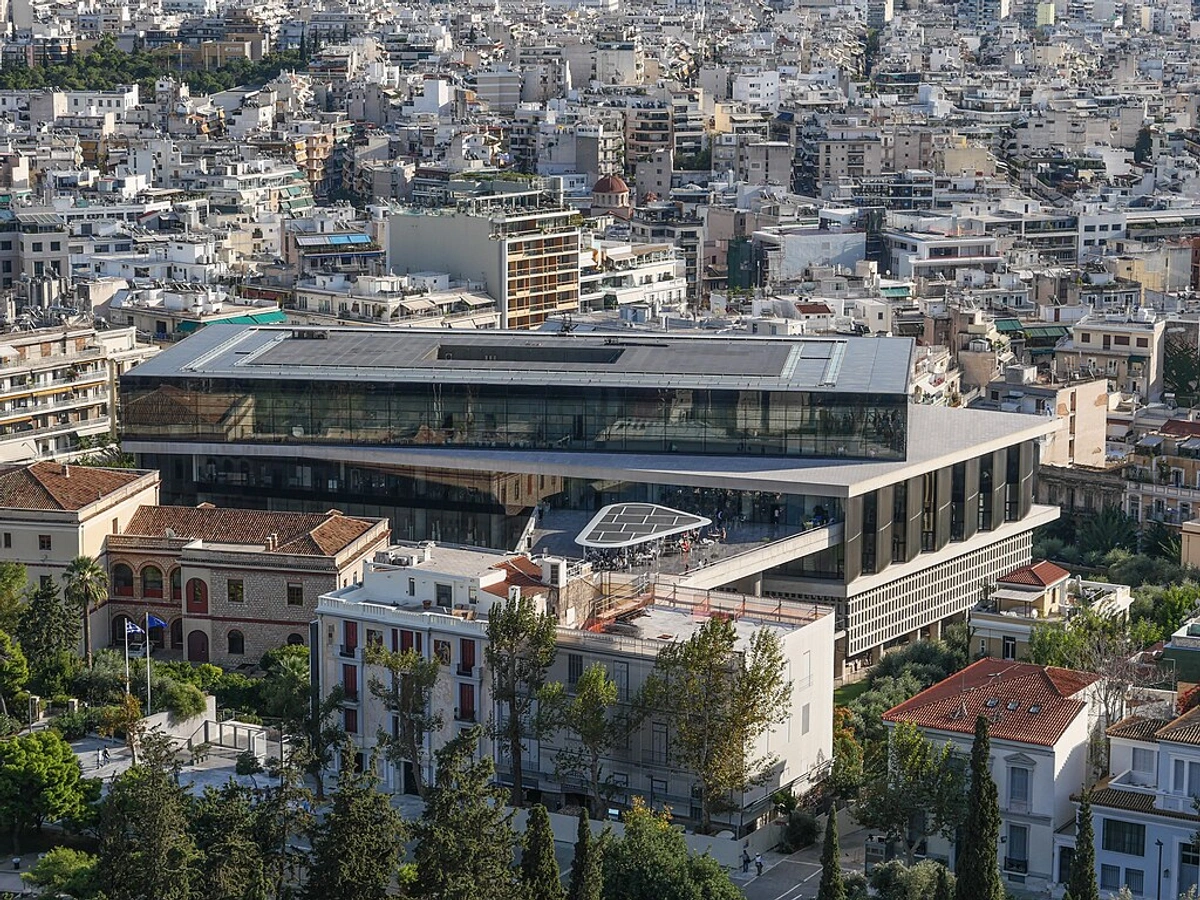 Elevated view of the modern Acropolis Museum in Athens, Greece, surrounded by the cityscape.