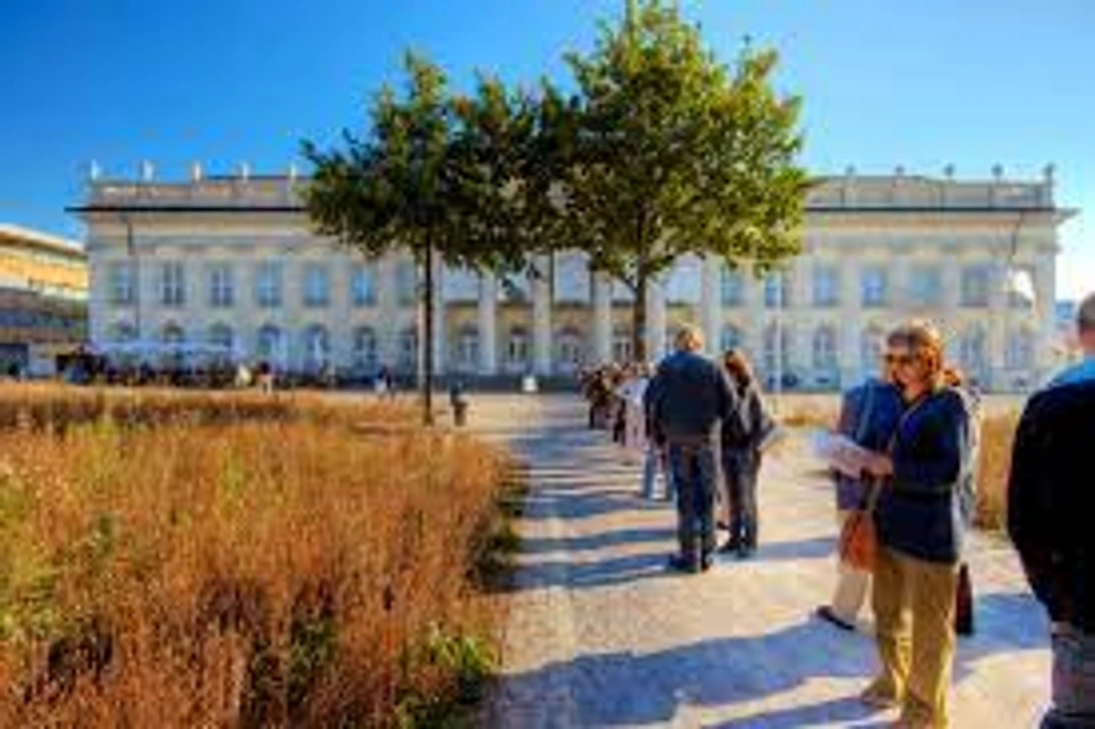 Palais de Rumine, Lausanne, Switzerland. Historic classical building with visitors on a sunny day.