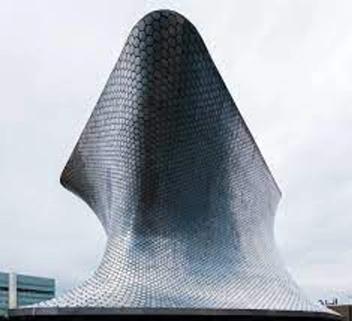 Soumaya Museum Mexico City, a modern silver building with a unique curved and hexagonal-tiled facade