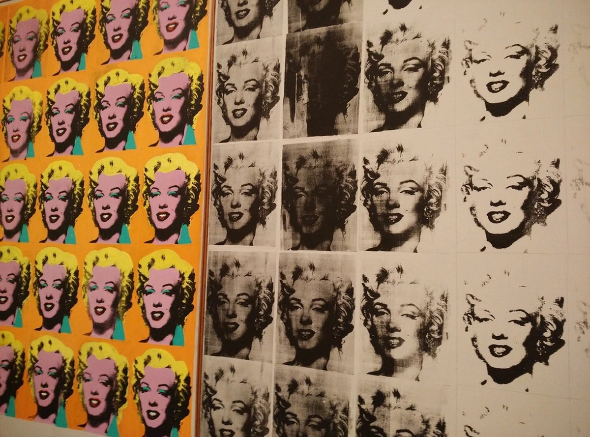 Close-up view of Andy Warhol's "Marilyn Diptych," featuring multiple screen-printed images of Marilyn Monroe in vibrant colors on the left and grayscale on the right.