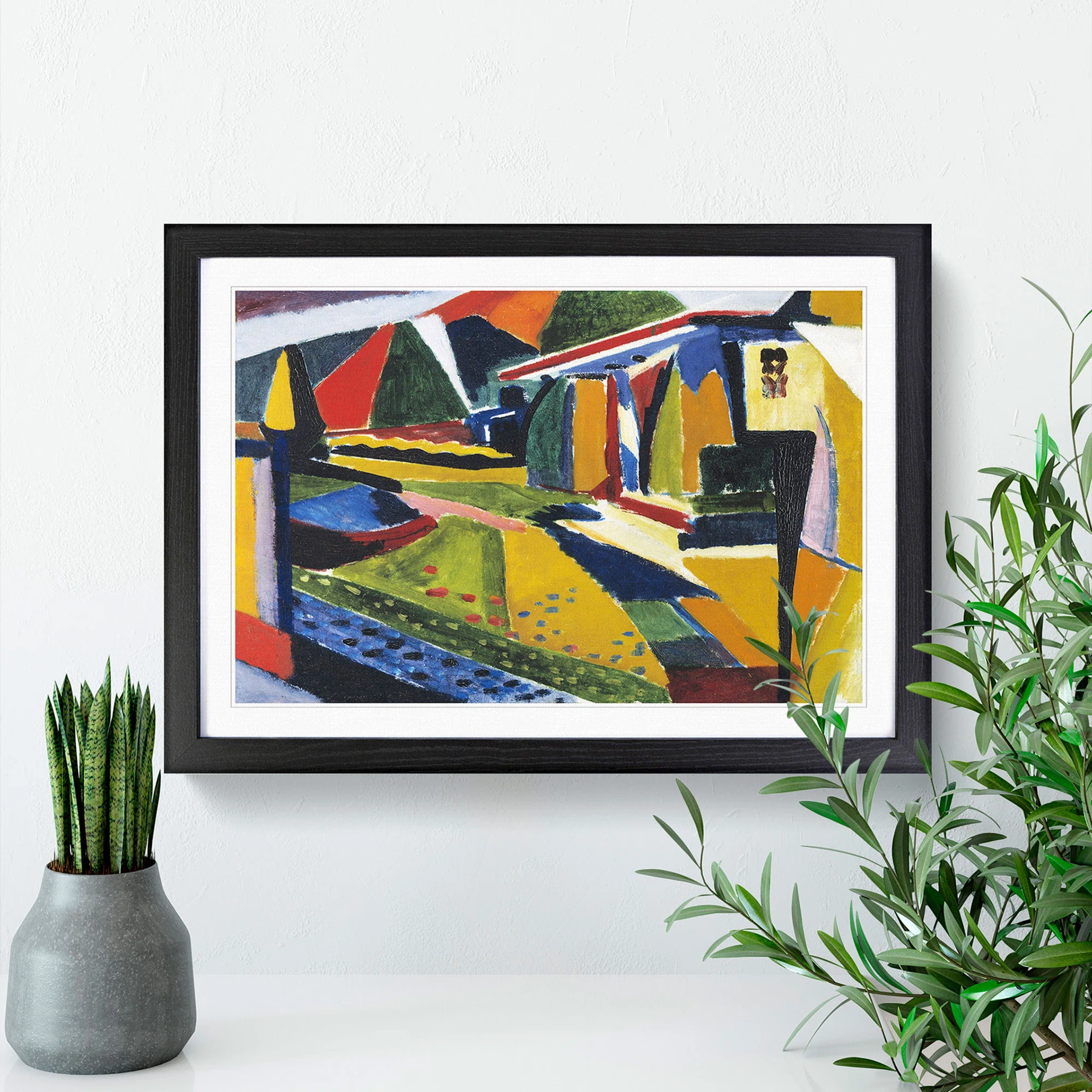 Ingelijst abstract landschapsschilderij van Henry Lyman Sayen met geometrische vormen en levendige kleuren, weergegeven op een witte muur met twee potplanten.
