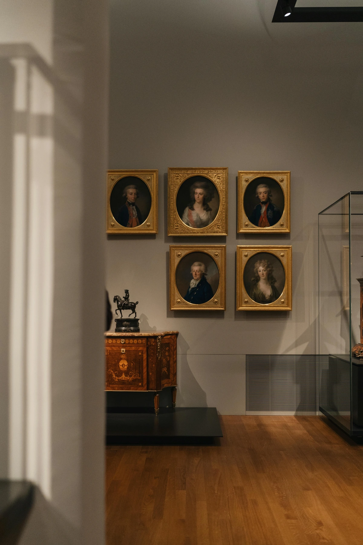 18th Century Portraits and Commode in Museum Gallery
